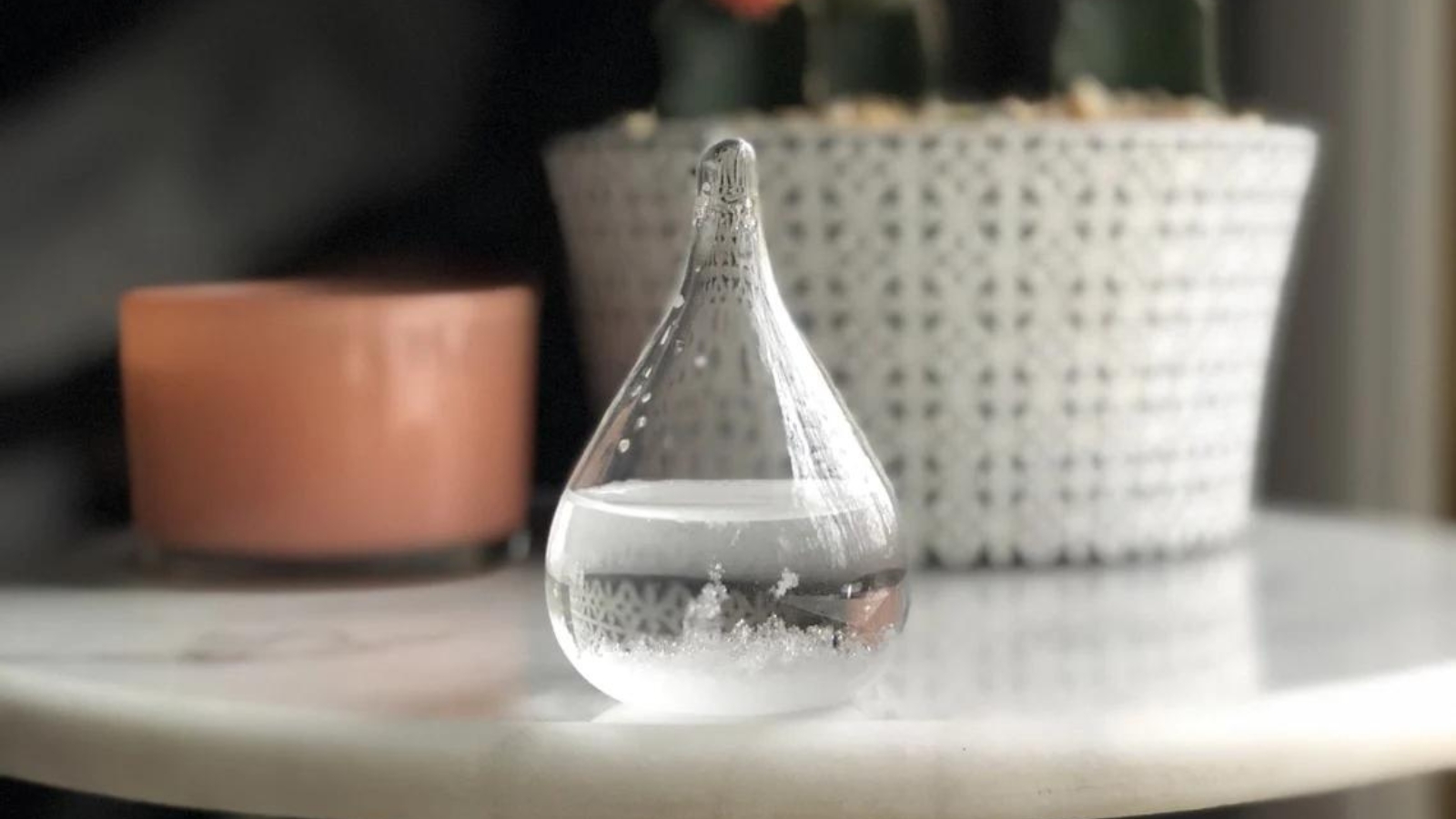storm glass in the shape of a tear drop that holds a liquid that changes according to weather conditions